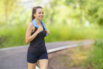 Healthy beautiful  young runner woman in sports outfits  workout outdoors in the park in the evening