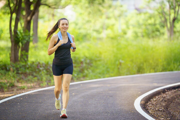 Healthy beautiful  young runner woman in sports outfits  workout outdoors in the park in the evening