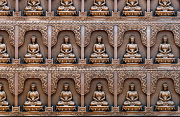 Group of Buddha statues on the wall