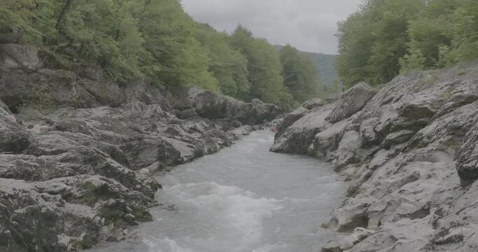 Aerial view of Mountain river and road. Flying over a mountain gorge. Slow motion 120 fps, ProRes 422, 10 bit ungraded DJI D-LOG video