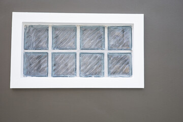Glass brick aperture on dark brown wall