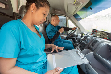 Doctor checking medical informs inside an ambulance