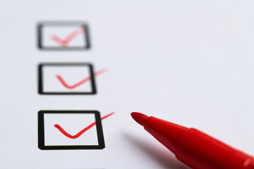 Red pen marking on checklist sheet