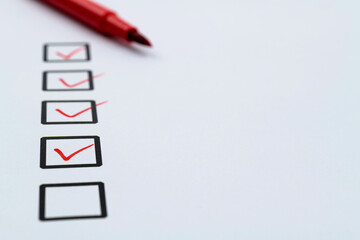 Red pen marking on checklist sheet