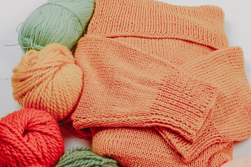 Knitting. Knitting warm clothes on your own. Tangles of wool and knitted things