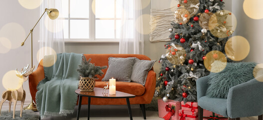 Interior of light living room with big Christmas tree and cozy furniture