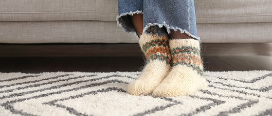 Young woman in warm socks at home, closeup