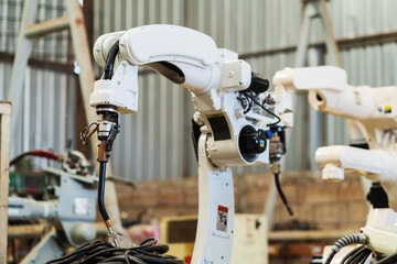 Robotic arm ready for work at production line in smart factory industrial. Automatic robot arm system welding machine in the industry factory. Industrial robot manufacturing technology