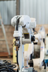 Robotic arm ready for work at production line in smart factory industrial. Automatic robot arm system welding machine in the industry factory. Industrial robot manufacturing technology