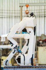 Robotic arm ready for work at production line in smart factory industrial. Automatic robot arm system welding machine in the industry factory. Industrial robot manufacturing technology