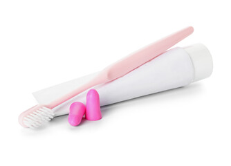 Ear plugs, toothbrush and paste on white background