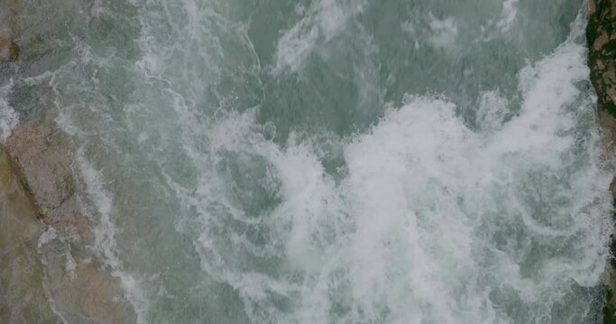 Mountain river. A rapid flow of clean water. Bubbling water, foam and splashes. Water flow in a mountain gorge, view of the water. Slow motion 120 fps, ProRes 422, 10 bit ungraded DJI D-LOG video