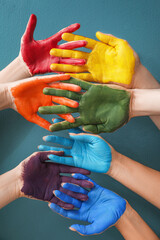 Hands with painted palms on blue background. LGBT concept