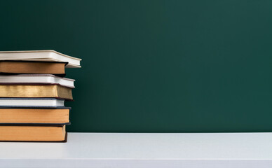 Stack books in front of the blackboard