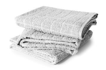 Stack of soft terry towels on white background