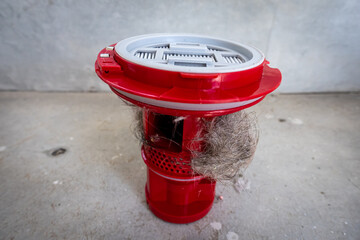 Household vacuum cleaner filter clogging up with dust, mite, hair, and animal fur after an extensive household cleaning : allergy, unhygienic concept