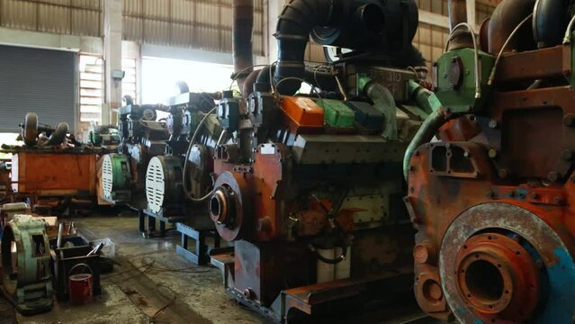 Engineer checking train engine Prepare for repainting for use in train stations. Engineers wear protective clothing and helmets to work safely as standard.
