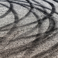 Black tracks on the pavement from a drift car. © sv_production
