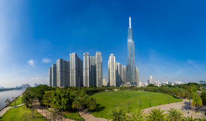 Morning view with sunny and green trees at Landmark 81 - it is a super tall skyscraper with...