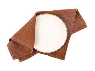 Plate with brown napkin on white background