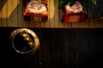 Traditional suburb Thai wooden house outdoor decoration with triangle pillow for rest and reclining in the morning sunlight. Sukhothai province, Thailand