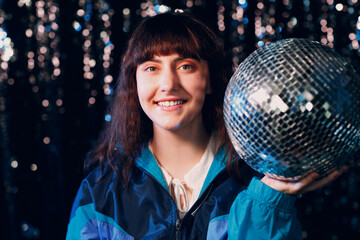 Young sporty woman 80 and 90's style. 90s fashion positive girl at night club disco party with...