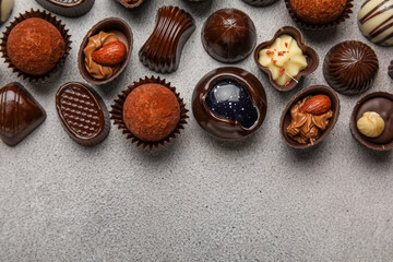Chocolate candies on grunge background, top view