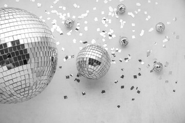 Disco balls with confetti on grey background