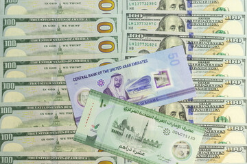 UAE new 50 dirham and new 10 dirham polymer bank notes over a new US 100 dollar bills