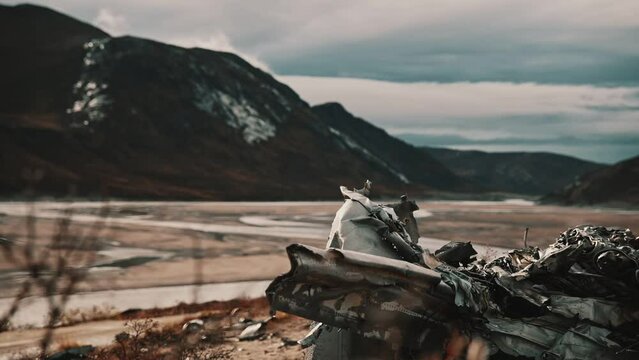 T-33 wreckage. Plane wreck in Kangerlussuaq. Medium closeup. panning left, booming up.