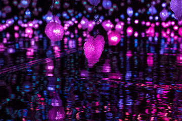 purple light ball in heart shape, in a dark room, mirror on the ground