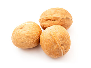 Close-up of three whole walnuts isolated on white, side view