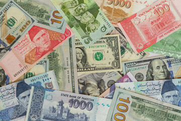Fototapeta na wymiar Pakistan bank notes with US dollar bills closeup