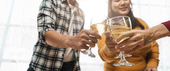 Group of happy colleagues having fun at a new year celebration or business success. Coworkers with diverse people at the office party