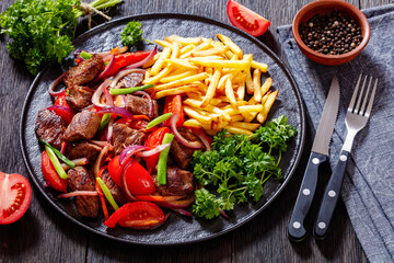Lomo saltado, fried beef, french fries, veggies