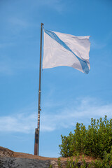 flag of galicia waving in the wind. Allariz, Ourense.