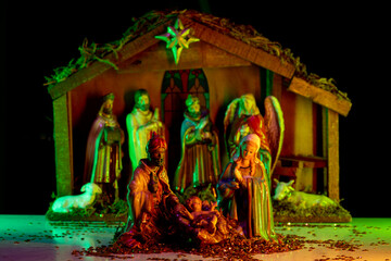 Jesus in manger. Christmas creche with Joseph Mary and Jesus. Christmas Manger scene with figurines...