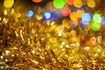 New Year's golden tinsel close-up and twisted bokeh