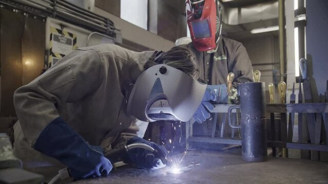 Welders working together in a metal shop