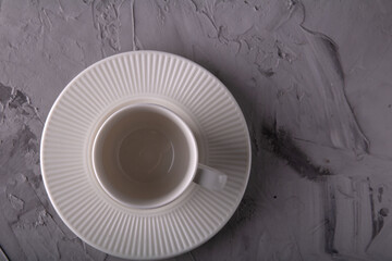 Obraz na płótnie Canvas photo of an empty white cup with a saucer