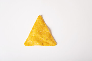 Corn nacho chips are triangular in shape on a white background. Mexican snack