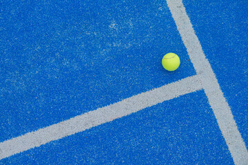 ball on a blue turf court paddle tennis court