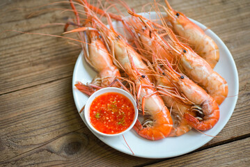 shrimp grilled delicious seasoning spices on wooden background appetizing cooked shrimps baked prawns , Seafood shelfish with seafood sauce