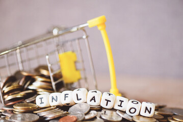 inflation with coin and shopping cart on wooden background, business economy inflation concept of...