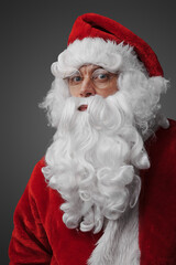 Shot of christmas santa claus with beard dressed in winter hat.