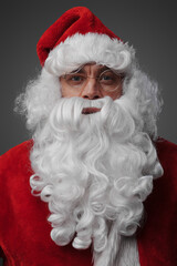 Headshot of santa claus with long beard and red costume isolated on grey.