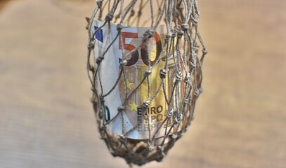 Fototapeta na wymiar 50 euro banknotes in natural cotton mesh