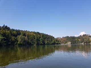 Fototapeta na wymiar Wonderful lake scenery in the mountains at the forest