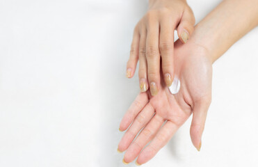 Woman applying cream on clean hand for beauty and spa treatment skin care on white background.