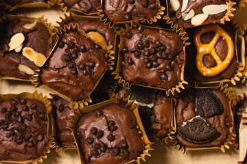 Chocolate brownies with cookies, chips and pretzels view from top. Sweet cakes dessert concept